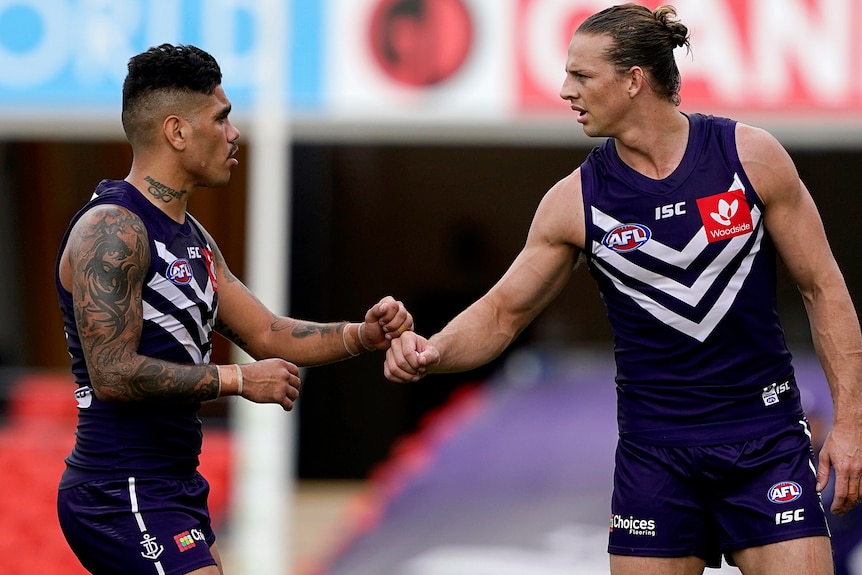 Michael Walters and Nat Fyfe share a fist bump after a win against St Kilda.