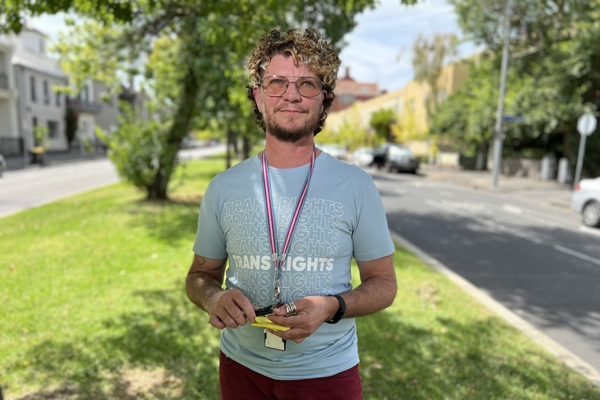 Person with curly hair and glasses 