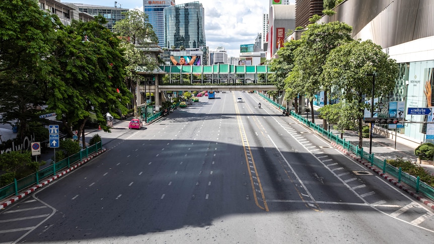 The busy Ratchaprasong intersection in Bangkok lies empty on the first day of new restrictions.