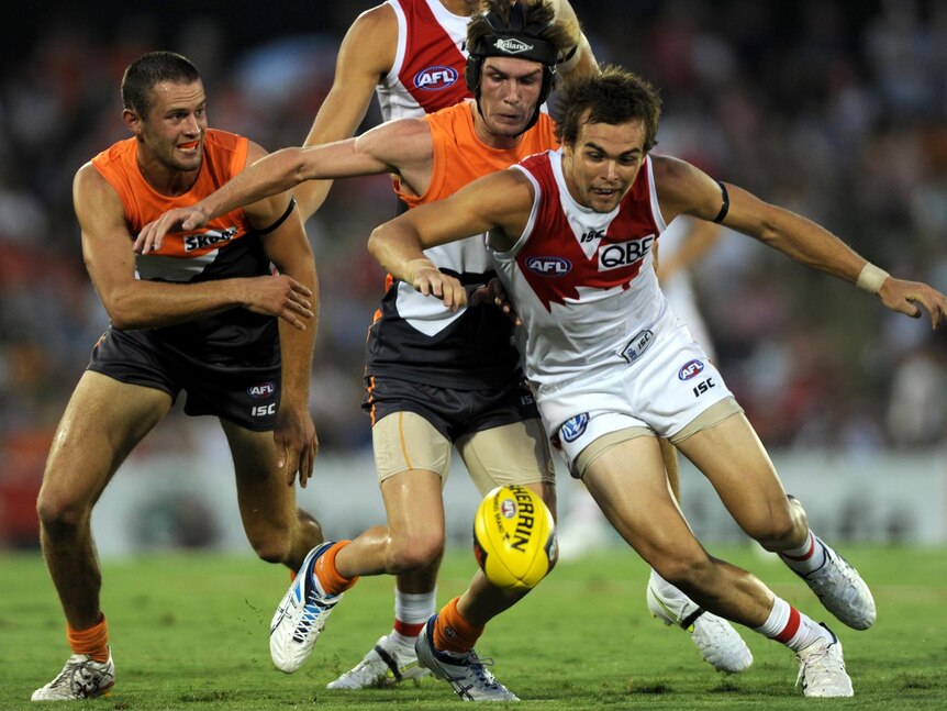 Sydney Swans players Lewis Johnson comes under pressure from the Greater Western Sydney Giants