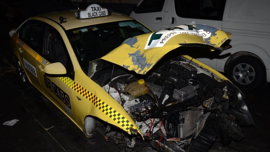 Police are searching for two people after they allegedly crashed a taxi driver's cab.