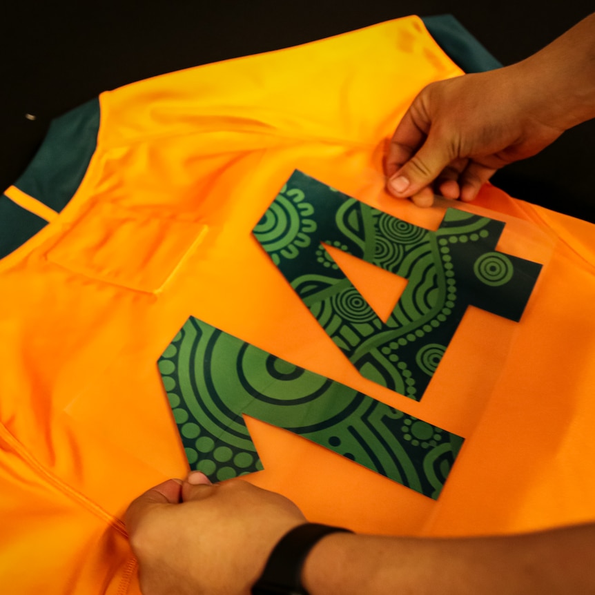 Indigenous pattern being put on the playing number of rugby union jersey