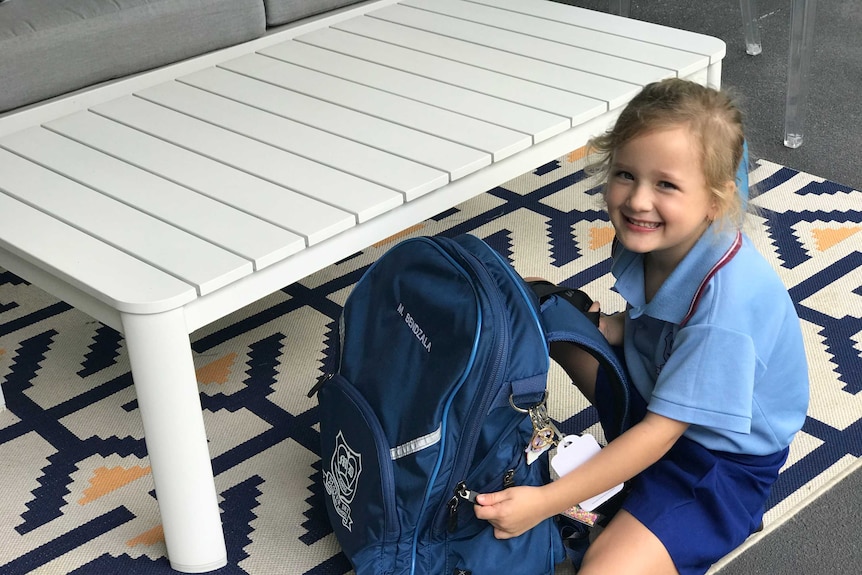 Prep student packs her school bag.
