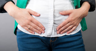 Woman holding her abdomen