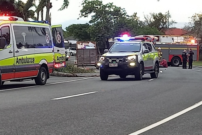 Emergency vehicles on a suburban road.