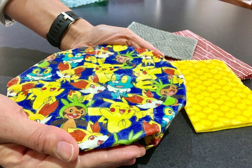 Emma Wake demonstrating how to wrap a plate of food with a bees wax wrap.