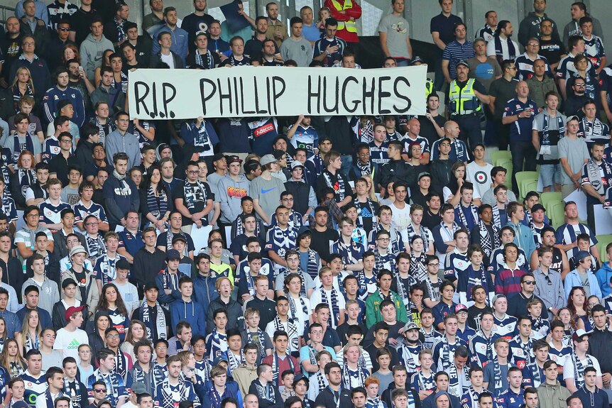Victory fans hold up a 'RIP Phillip Hughes' sign