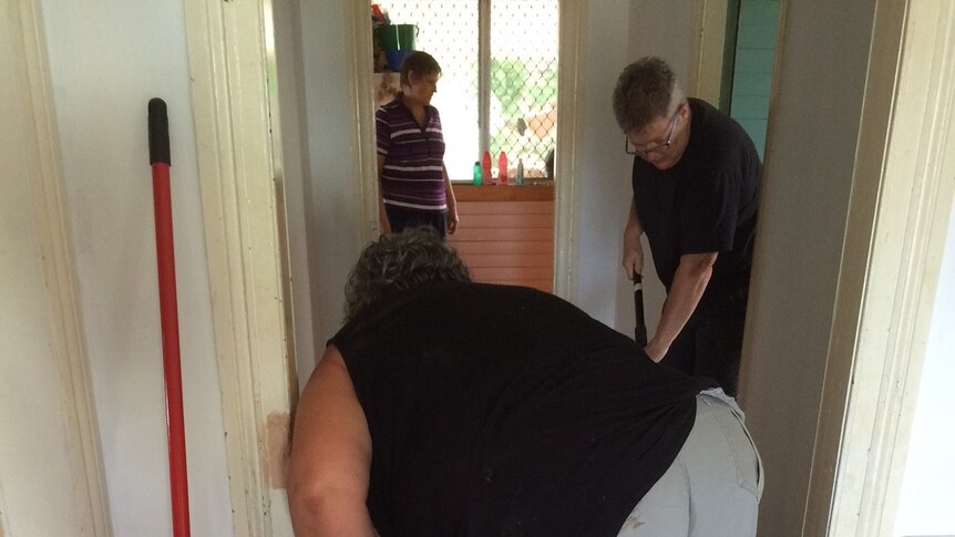 Jo Grove's friends help clean up after flood water decimated her home.