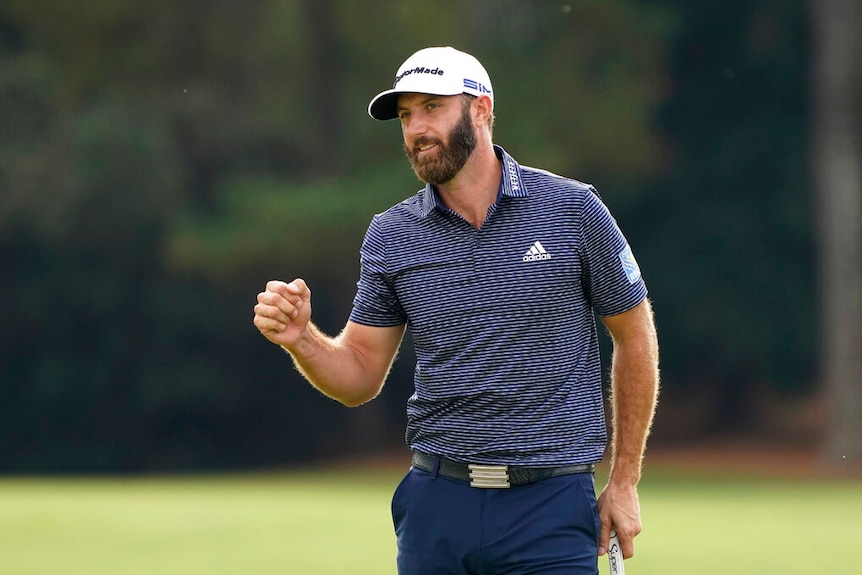 A golfer clenches his fist in victory