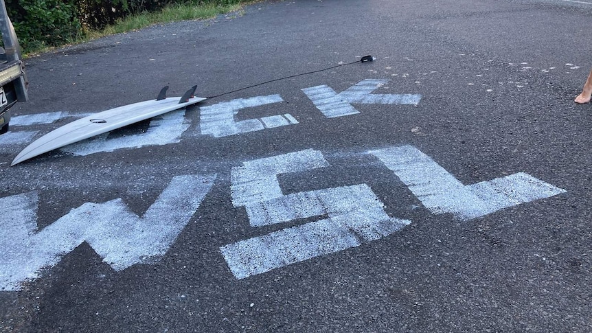 A sign painted onto the tar in a Lennox Head carpark says F**K WSL.