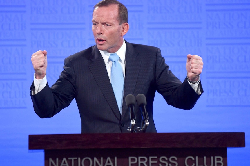 Prime Minister Tony Abbott shows fists while speaking at The National Press Club in Canberra