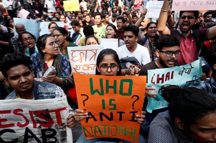 Students hold placards and shout slogans in solidarity with Jamia Millia Islamia university.