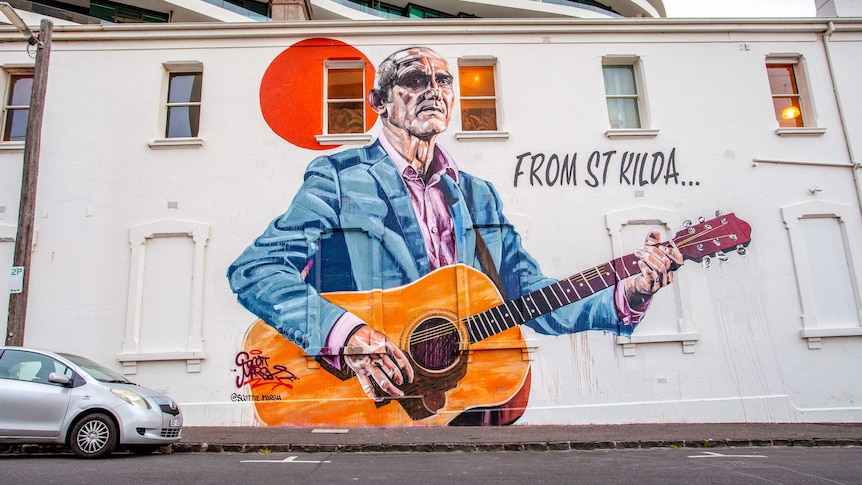 A Paul Kelly mural on the side of a building.