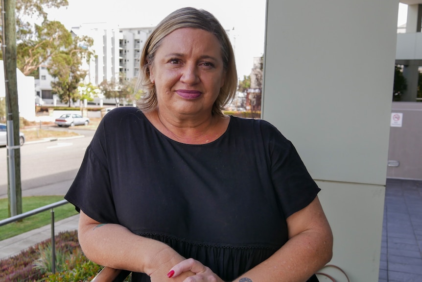 A woman standing on an office balcony