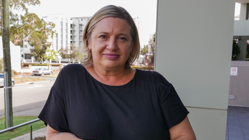 A woman standing on an office balcony