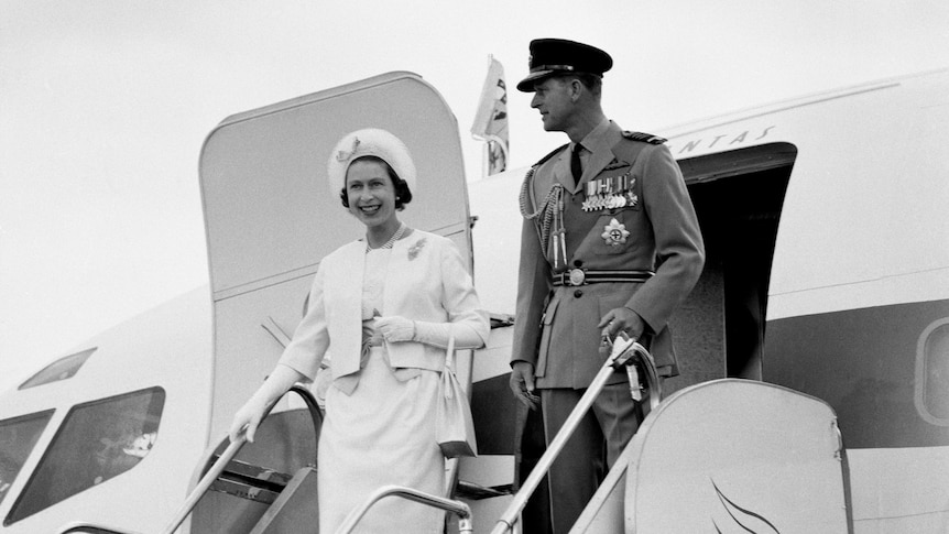 Queen Elizabeth II and the Duke of Edinburgh wave as they step off a plane, on their second visit to Australia in 1963