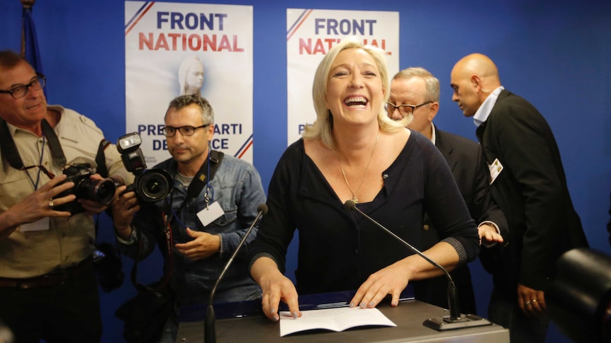Marine Le Pen smiles broadly after hearing results after the polls closed.