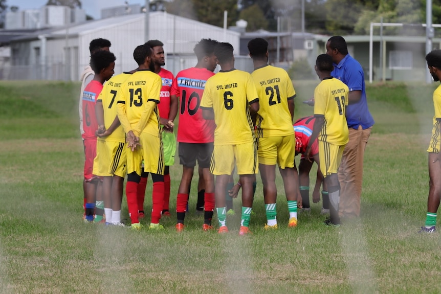 Ramadan Cup grand final contenders Syl United engaged in a team huddle. 
