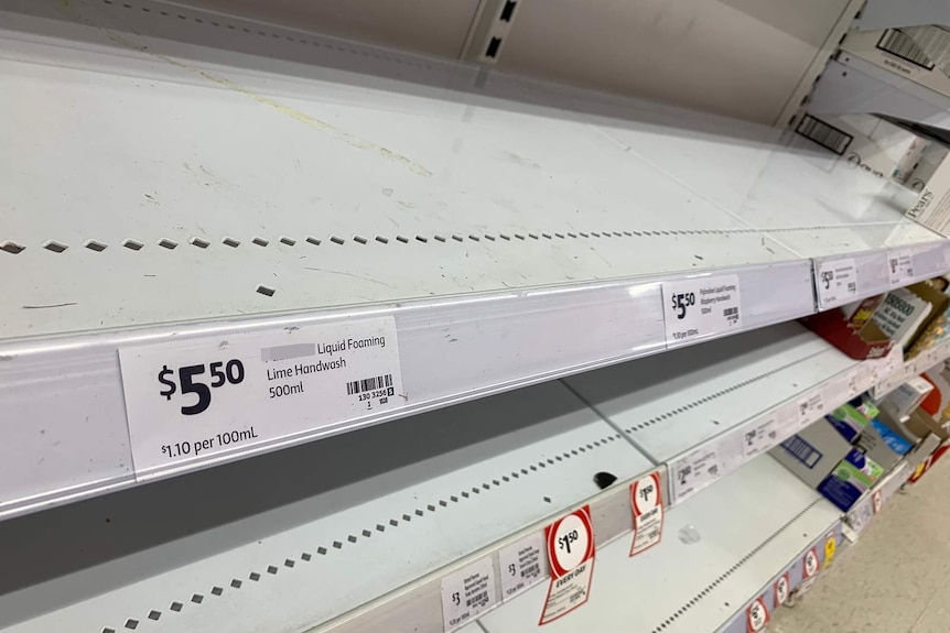 A supermarket handwash shelf stripped of product