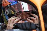 Daniel Ricciardo sitting in his McLaren.