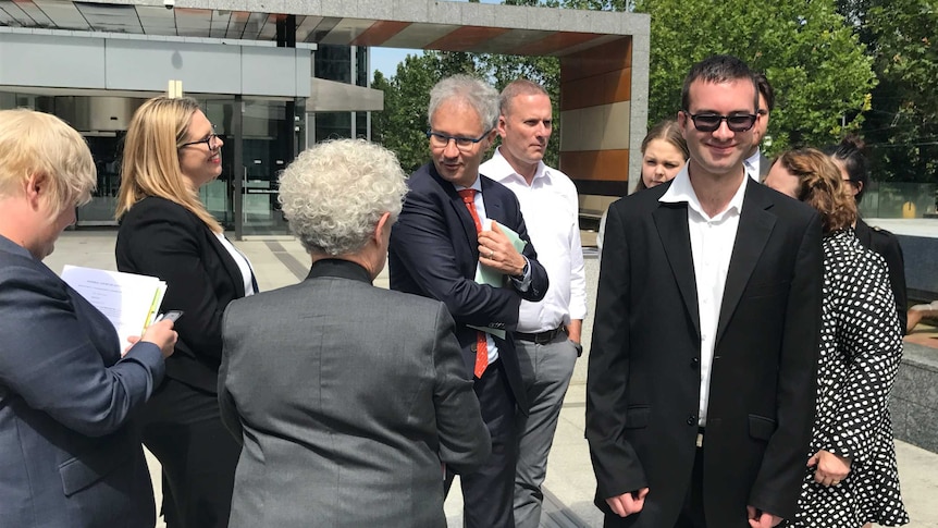 Tyson Duval-Comrie smiles outside the court, after a ruling in his favour.