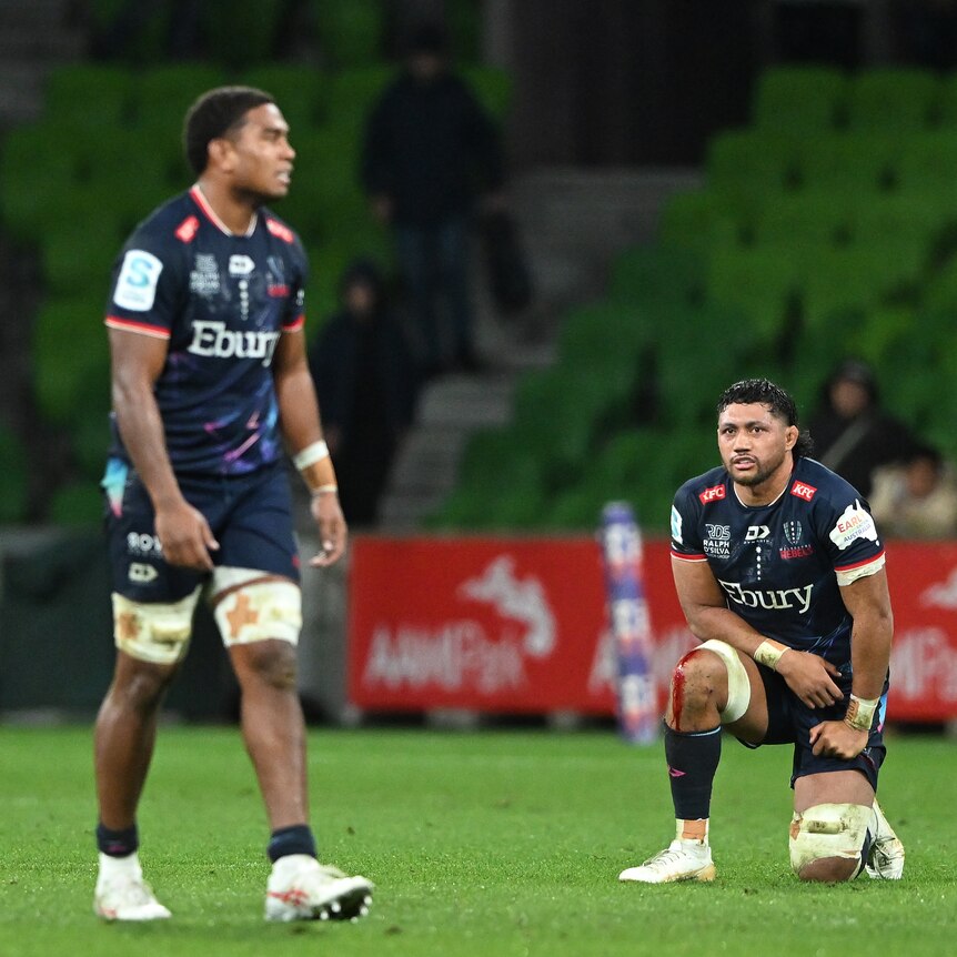 Melbourne Rebels players look upset after losing a Super Rugby Pacific match.