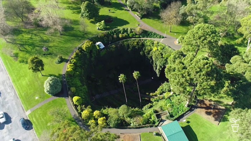 Parkland garden with large circular sinkhole with garden inside