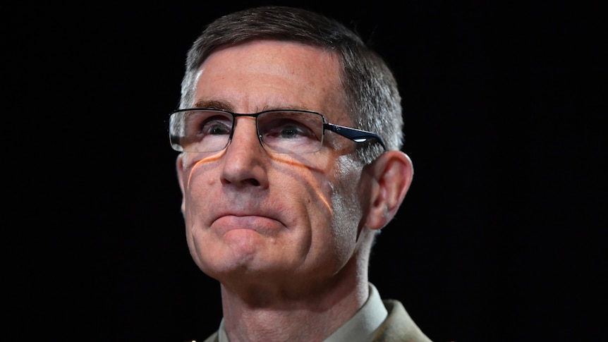 General Angus Campbell wearing glasses and uniform looking left of camera