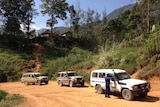 A convoy of land cruisers in the mountains of Papua New Guinea.