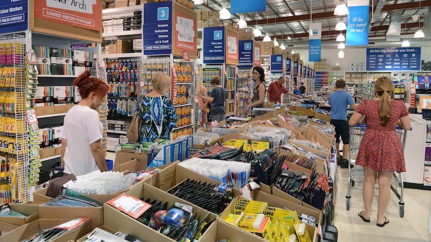 People shop in an Officeworks store