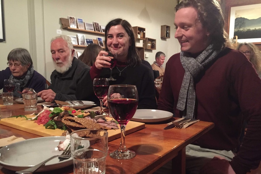 Visitors eating at table.