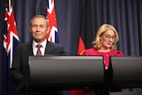 Roger Cook stands beside Rita Saffioti at the podium as they are both smiling