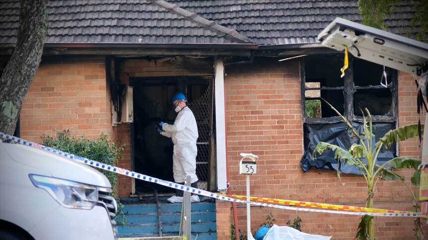 a forensic officer at the property after a fatal fire at lalor park in sydney's west claimed the life of three children