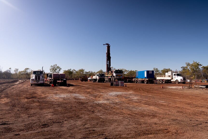 A gas fracking well established in a clearing in scrubland. 