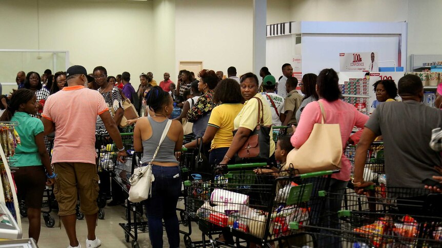 Jamaicans stock up with supplies at a supermarket ahead of the arrival of Hurricane Matthew, September 30, 2016.