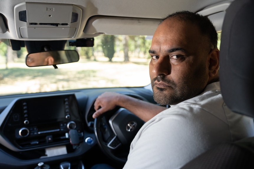 A man in the driver's seat of a car.