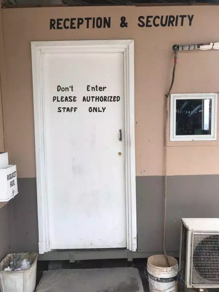 Security and reception booth at Anibare Lodge, Nauru. The sign on the door says "authorized staff only"