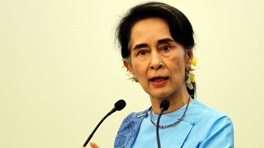 Myanmar Foreign Minister Aung San Suu Kyi gestures while speaking at a meeting.