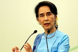 Myanmar Foreign Minister Aung San Suu Kyi gestures while speaking at a meeting.