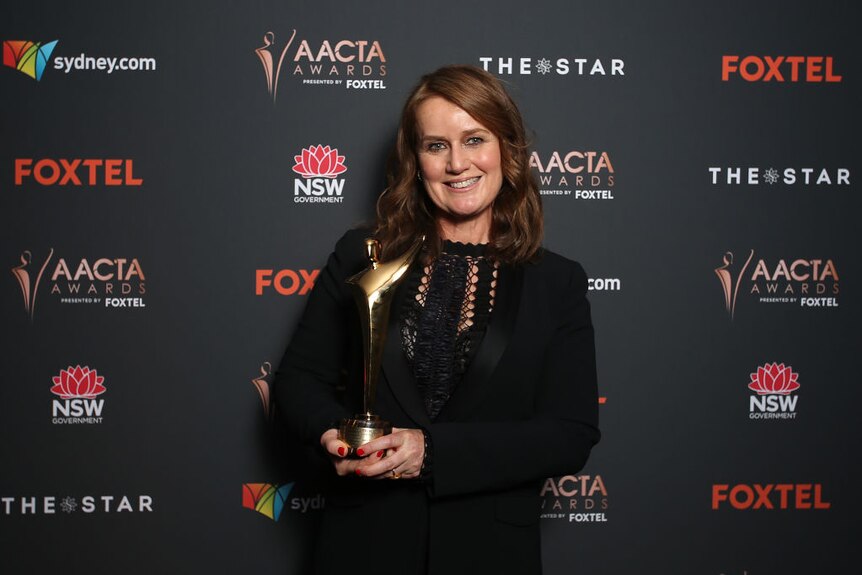 Elise McCredie smiles as she holds her AACTA Award at The Star