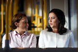 Queensland Premier Annastacia Palaszczuk (right) and Deputy Premier Jackie Trad take a ride on the Light Rail on the Gold Coast.
