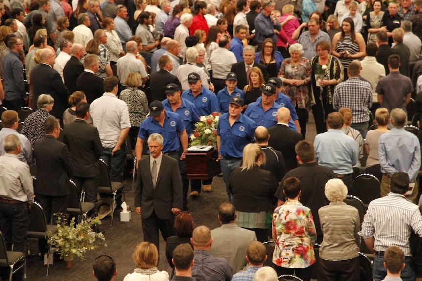 Billy Hayes coffin is carried out of his packed funeral service.