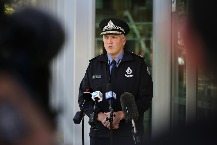 A mid-shot of WA Police Commissioner Col Blanch speaking into microphones.