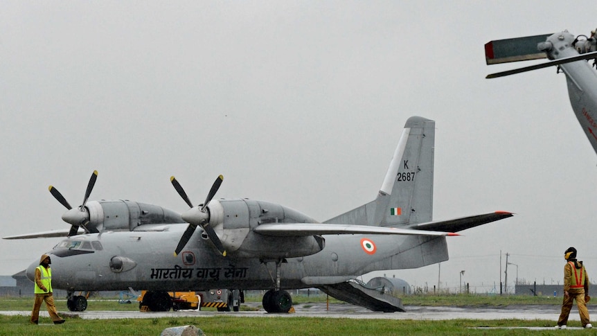 Indian Air Force Antonov An-32 transport aircraft sits on ground as rain falls