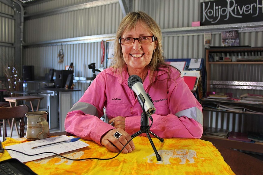 Leanne Drew smiling at the camera. She is wearing a pink, hi-vis shirt