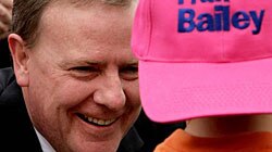 Peter Costello talking with a young boy in a cap