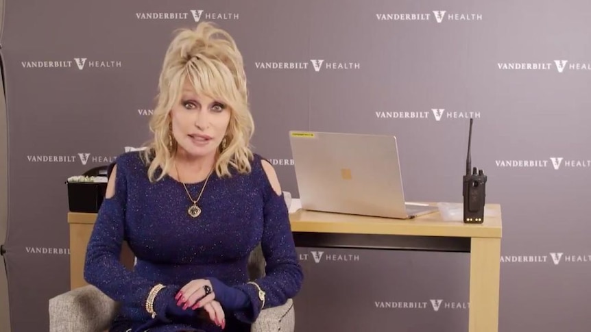 Dolly Parton sings altered version of her hit song "Jolene" as she receives her first dose of Moderna vaccine