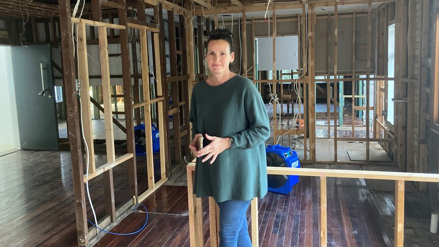 Tanya Ryall inside her flood-damaged home at Ashgrove in Brisbane.