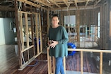 Tanya Ryall inside her flood-damaged home at Ashgrove in Brisbane.