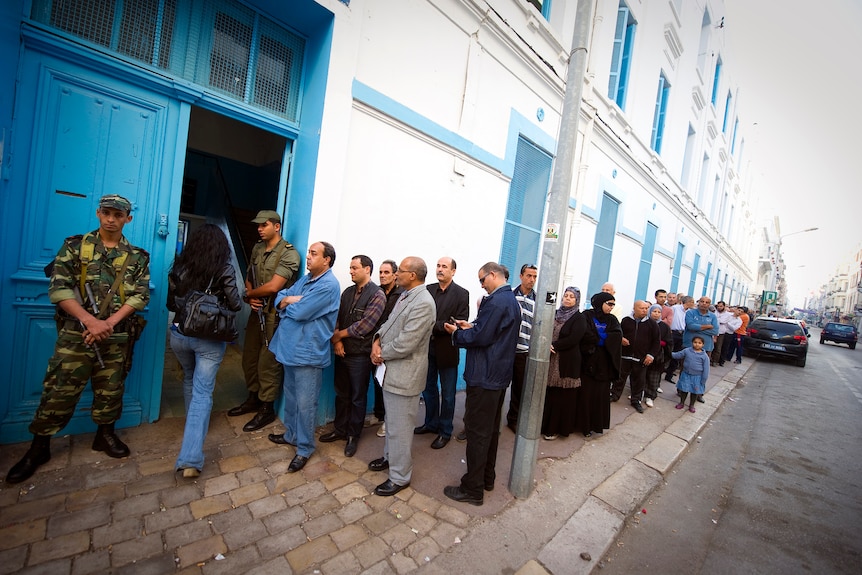Tunisians queue on October 23, 2011, in front of a polling station in Tunis.